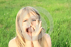 Girl playing on halm of grass