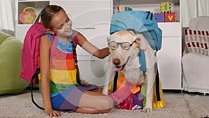 Girl playing with her clever dog - preparing for school