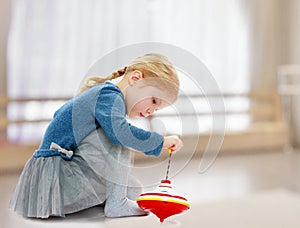 Girl playing humming top.