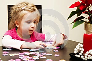 Girl playing with jigsaw puzzle