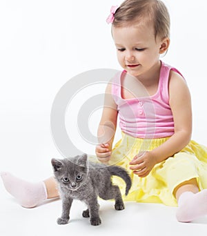 Girl playing with a kitten