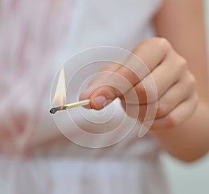 Girl playing with match.