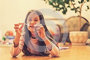 Girl playing with matches. Dangerous situation at home. A small child plays with matches, a fire, a fire flares up, danger, child