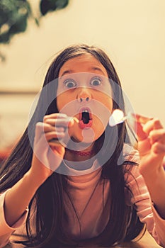 Girl playing with matches. Dangerous situation at home. A small child plays with matches, a fire, a fire flares up, danger, child