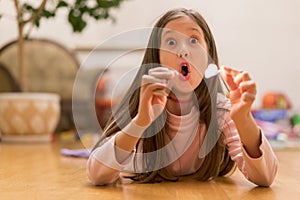 Girl playing with matches. Dangerous situation at home. A small child plays with matches, a fire, a fire flares up