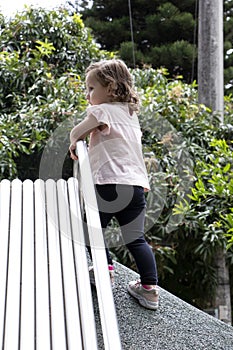 Girl playing in metal slide game in park