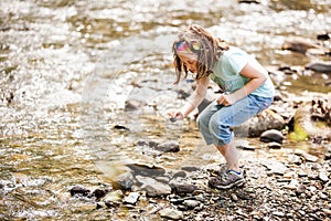 Girl playing near the water