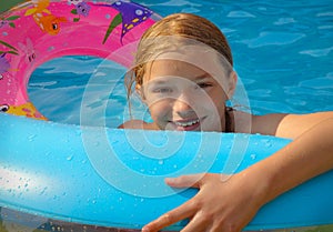 Girl playing in paddling pool photo