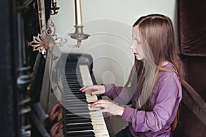 Girl playing piano at musical school