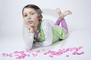 Girl playing with pink grit