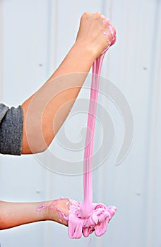 Girl playing with pink slime