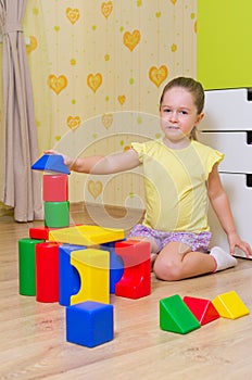 Girl playing with plasic cubes