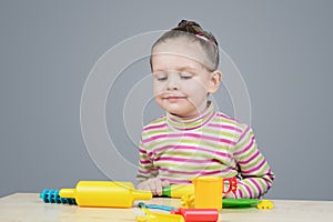 Girl playing with plastic tableware