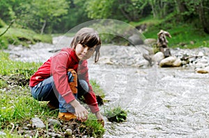 Girl playing by river