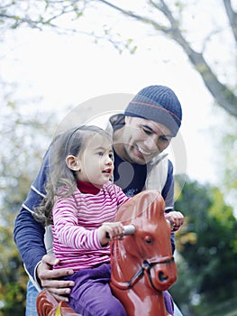 Girl Playing On Rocking Horse