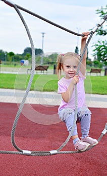 Girl playing on a rope swing