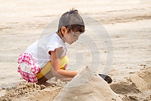 Girl playing sand.