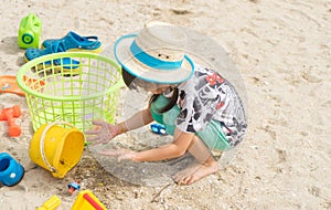 Girl playing with Sand beach toy.