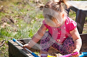 Girl playing in sand box