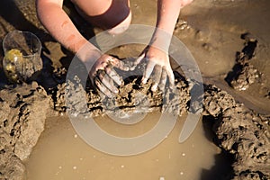 Girl playing in the sand on the lake