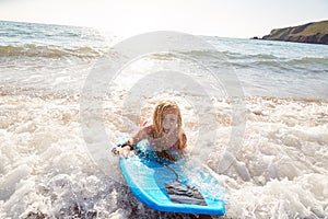 Girl Playing In Sea With Bodyboard On Summer Beach Vacation