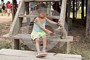 Girl playing with sloth