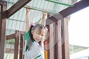 Girl playing and smiles in school playground