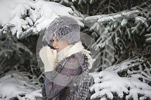 Girl playing with snow in park