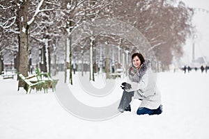 Girl playing snowballs in Tuilleries, Paris photo