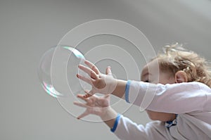 Girl playing with soap bubbles