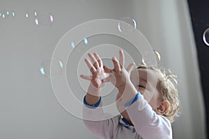 Girl playing with soap bubbles