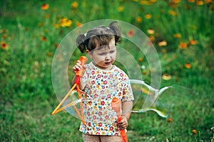 Girl playing with soap bubbles in the Park