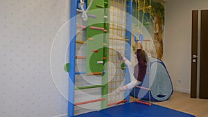 Girl playing sports on the wall bars