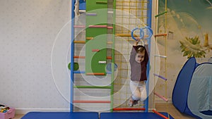 Girl playing sports on the wall bars