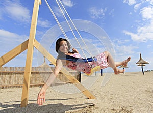 Girl playing on a swing-set