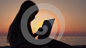 Girl Playing Tablet on Beach, Sunset View Child Silhouette Using Smart Phones 4K