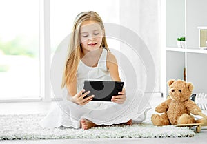 Girl playing tablet computer