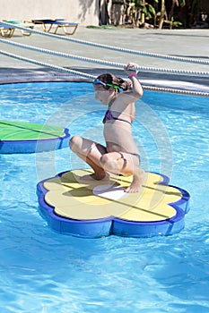 Girl playing in tarzan pool