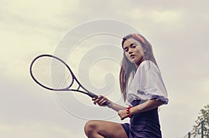 Girl playing tennis on green court