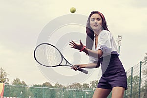 Girl playing tennis on green court