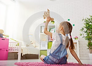 Girl playing with toy airplane