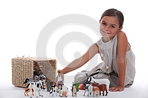 Girl playing with toy animals
