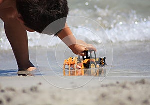 Girl playing with toy on beach