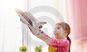 Girl playing with toy rocket