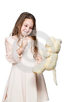 Girl playing with a toy teddy bear