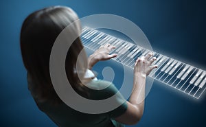 Girl playing on virtual piano keyboard