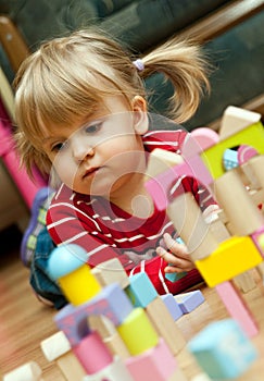 Girl playing with wood blocks