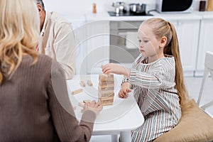 girl playing wood blocks game near