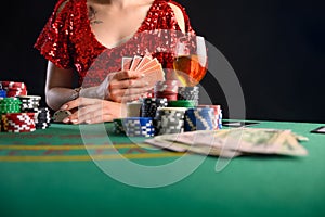 Girl plays cards in a casino, a lot of chips, cards, video. Success and win. Poker