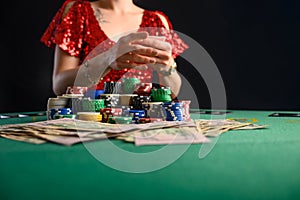 Girl plays cards in a casino, a lot of chips, cards, video. Success and win. Poker